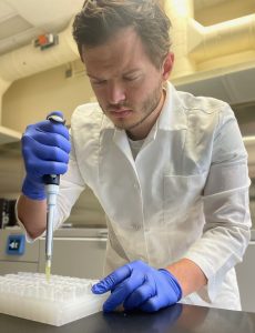 CALS graduate student John Larsen researches unwelcome “stink” and other defects in aged cheese